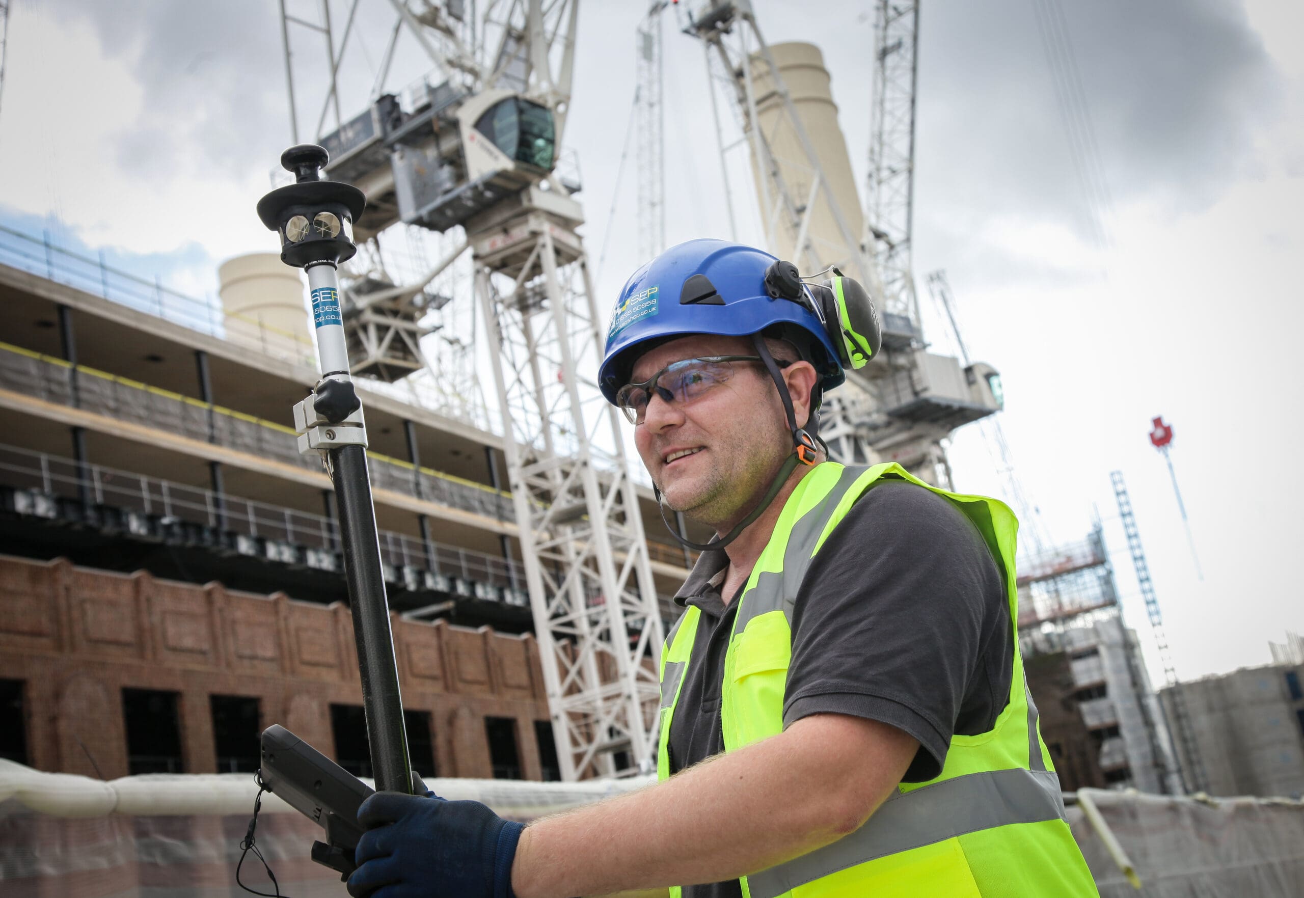 Setting out engineer working on site in West London